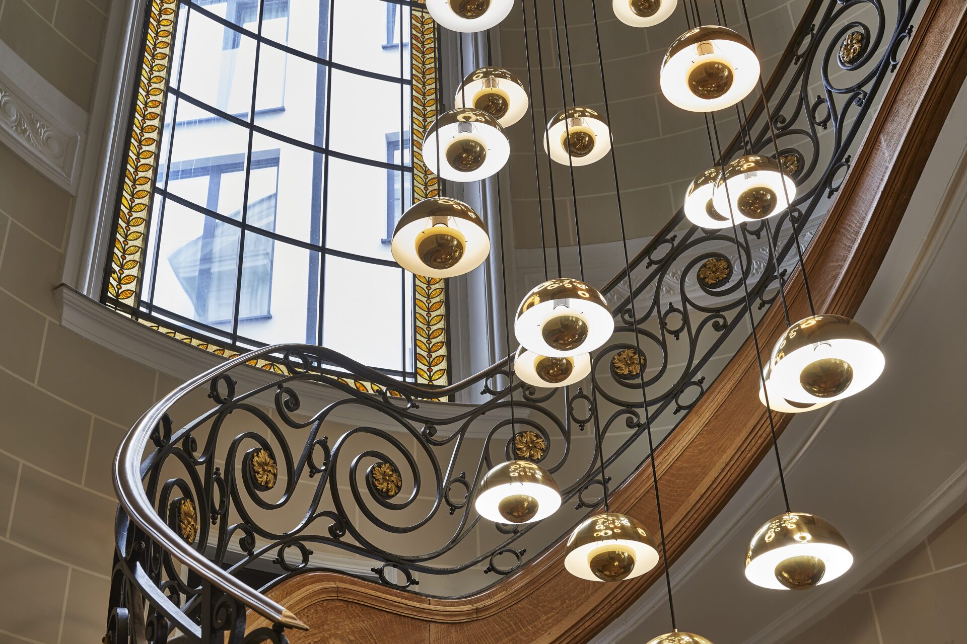The stained-glass window and the staircase of the Hygge Hotel Brussels