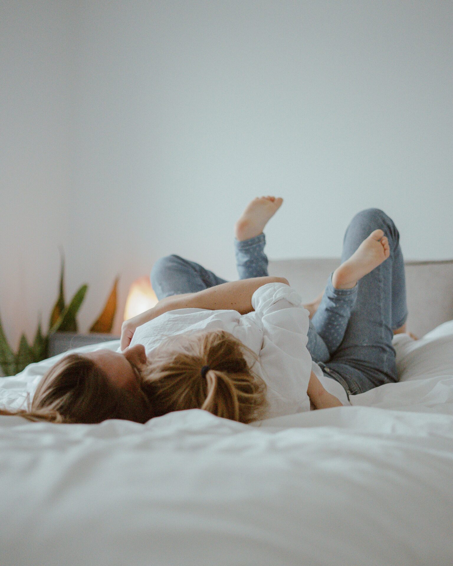 mother and daughter lying in the bed
