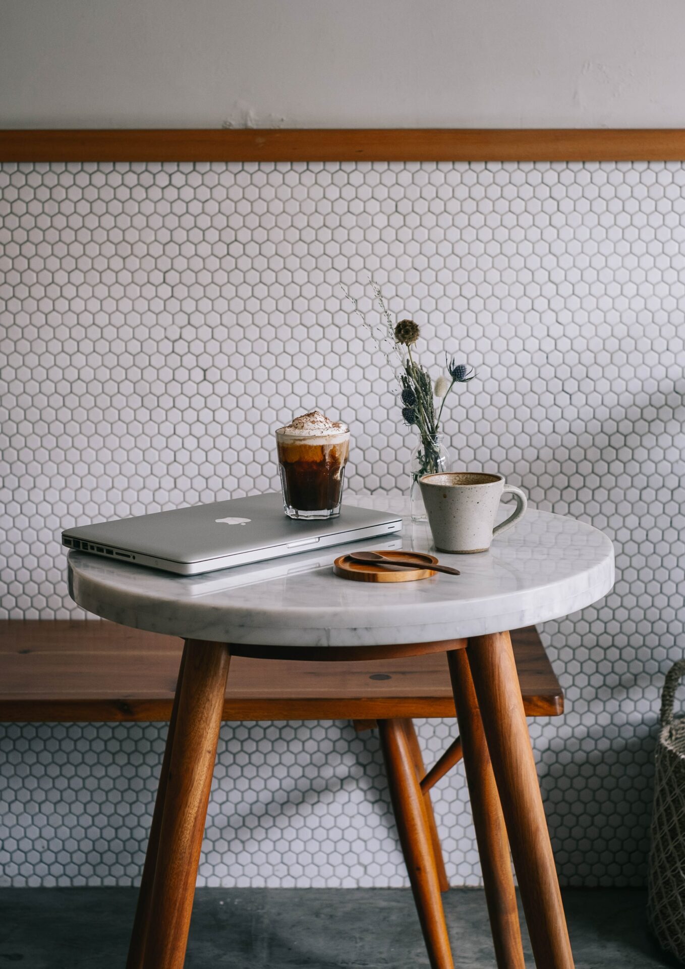 round table with a laptop and two coffee cups on it
