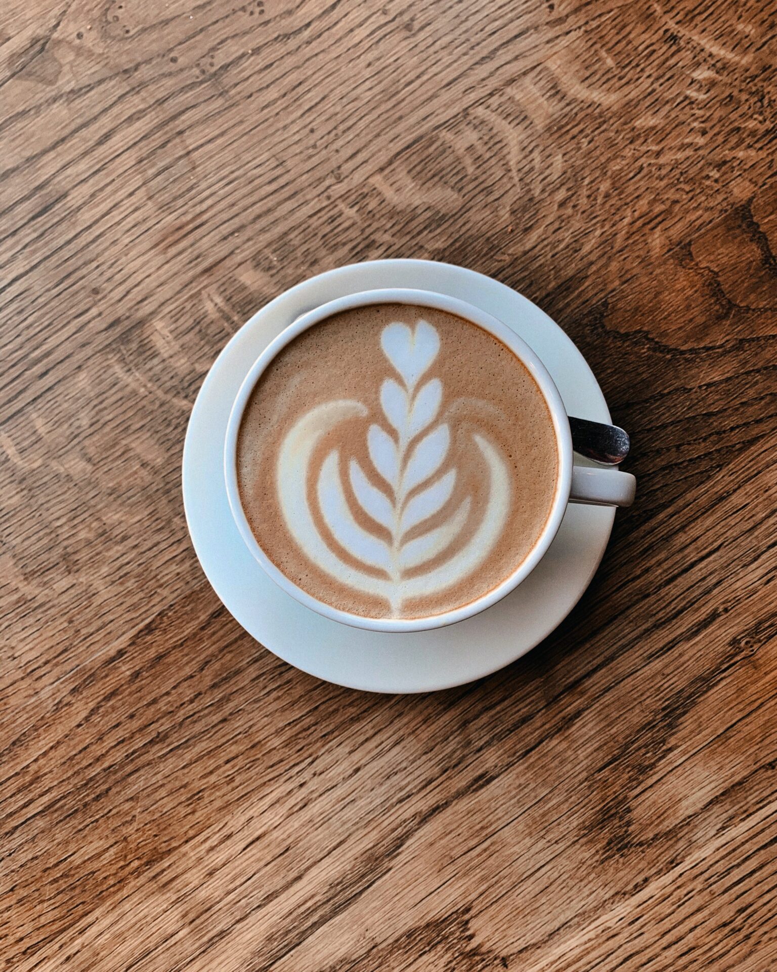 white cup of cappuccino - Hygge hotel a cup of coffee